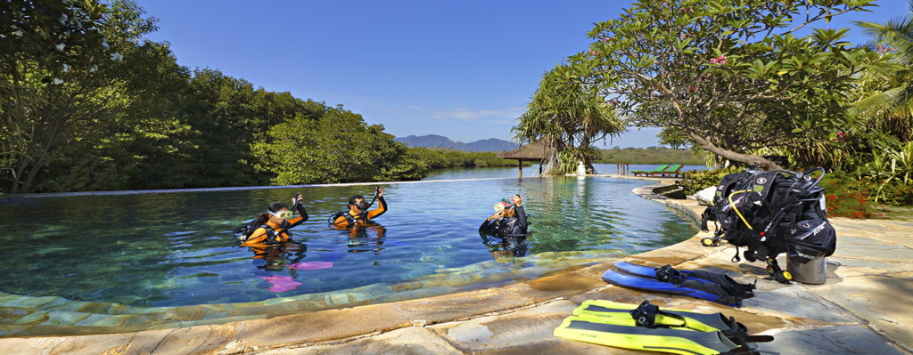 Two students and an instructor during PADI Open Water Dive course in the pool at Mimpi Resort Menjangan, West Bali